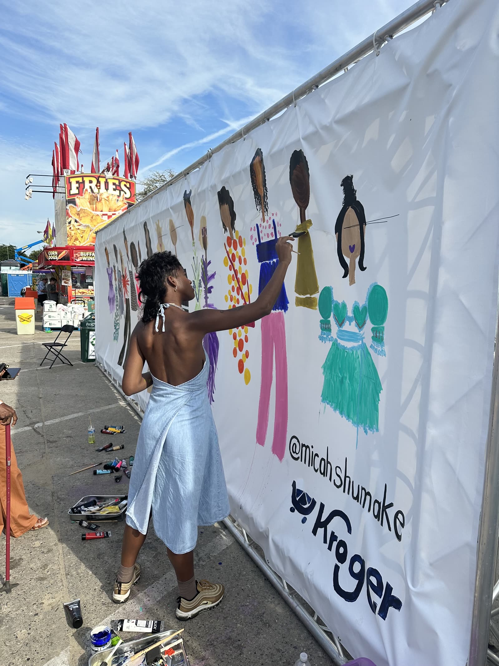 Micah painting a mural on-site